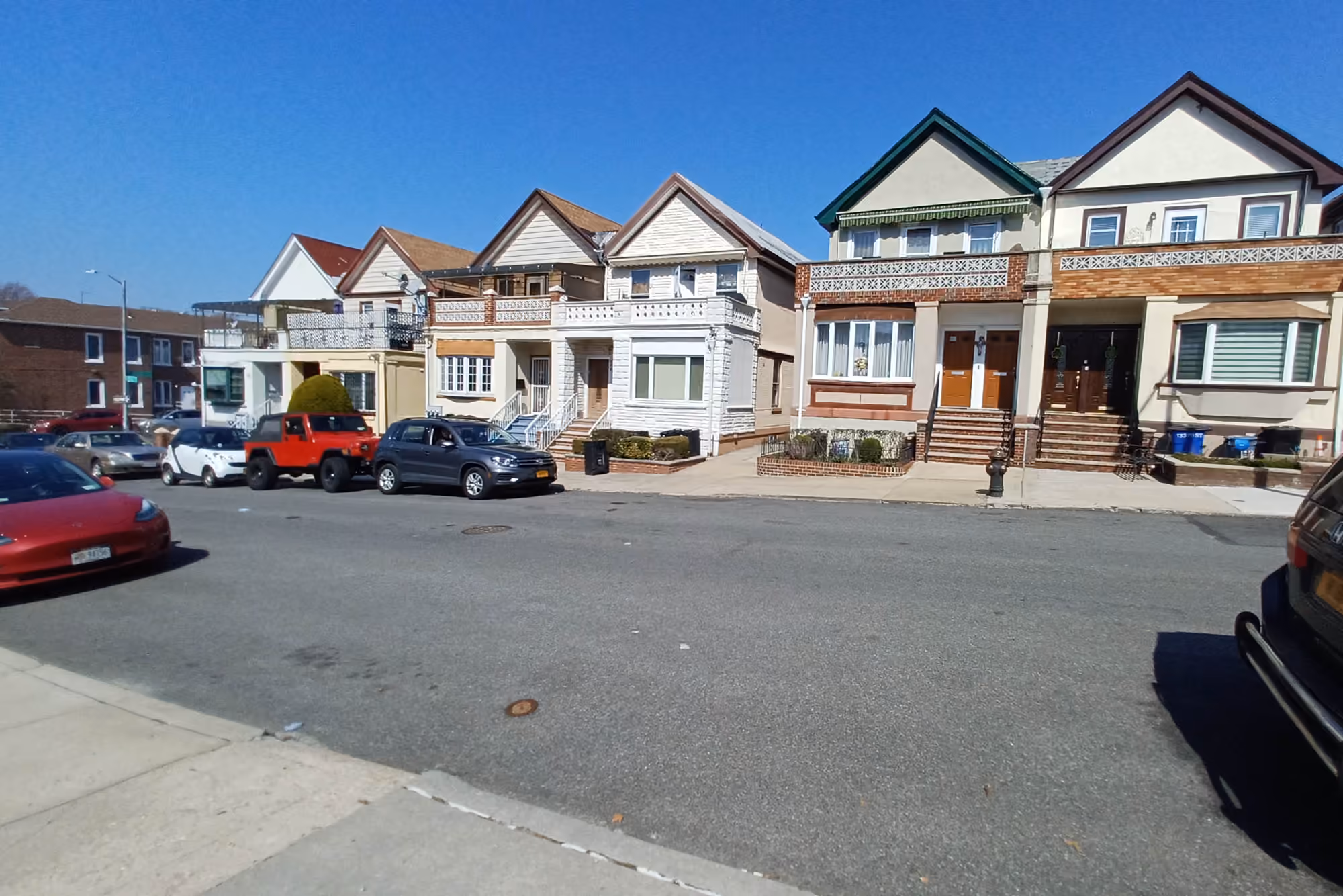 Residential houses with varied rooflines along 70th Street in Bay Ridge