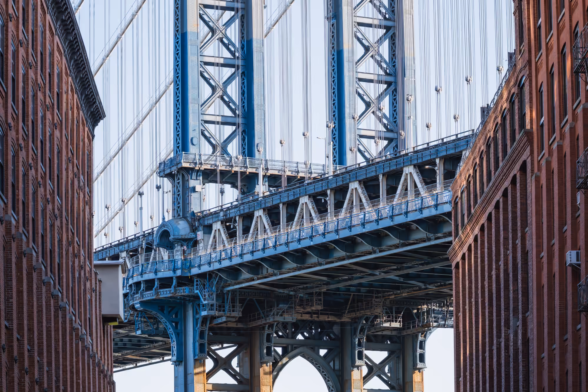 The Manhattan Bridge framed by the brick buildings of Washington Street in DUMBO