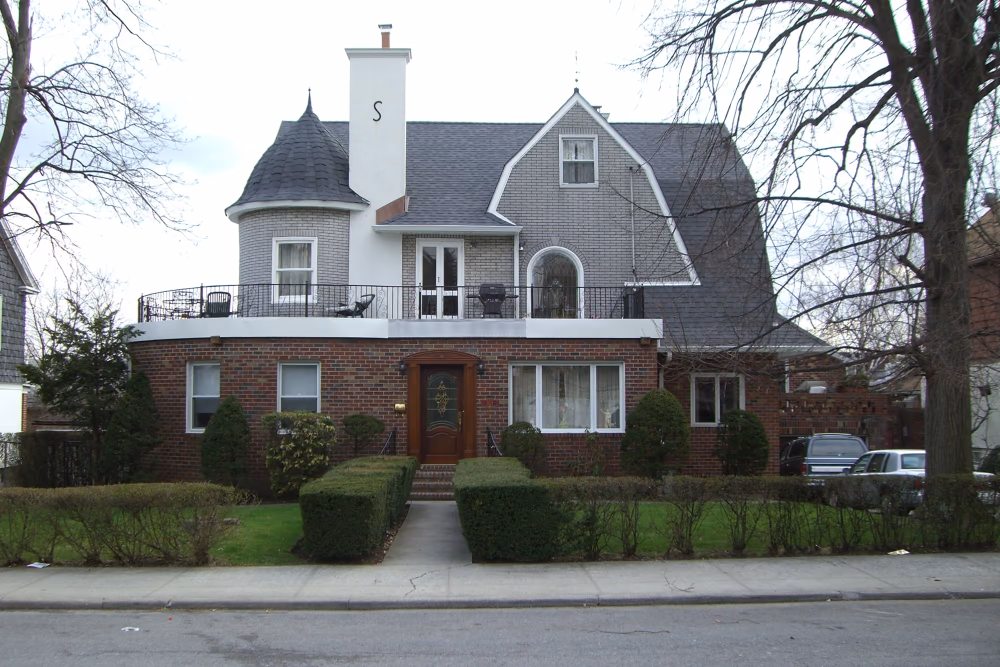 Historic residence with a turret and landscaped front garden in Dyker Heights