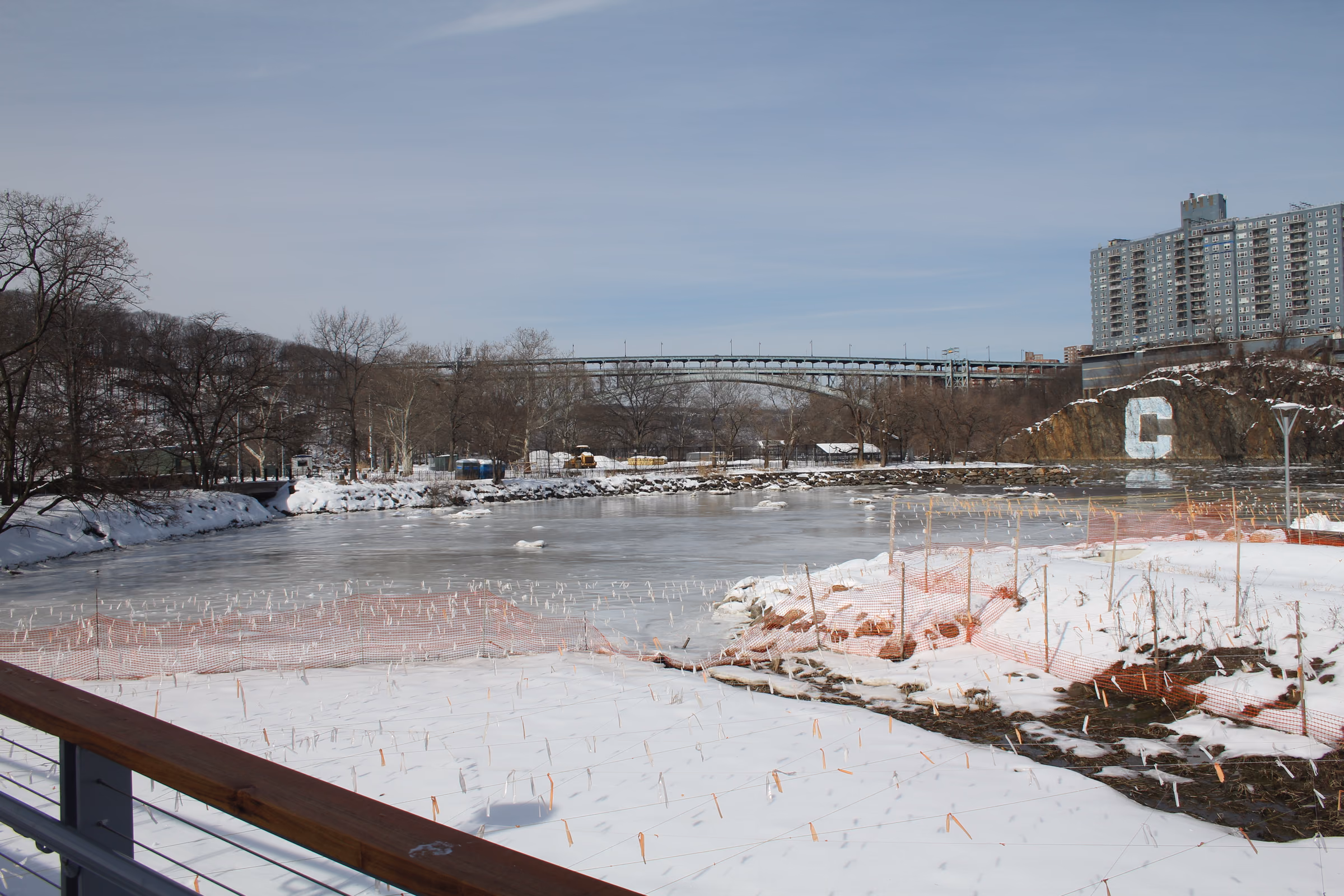 Snow-covered Muscota Marsh beside Inwood Hill Park, with the Henry Hudson Bridge beyond.