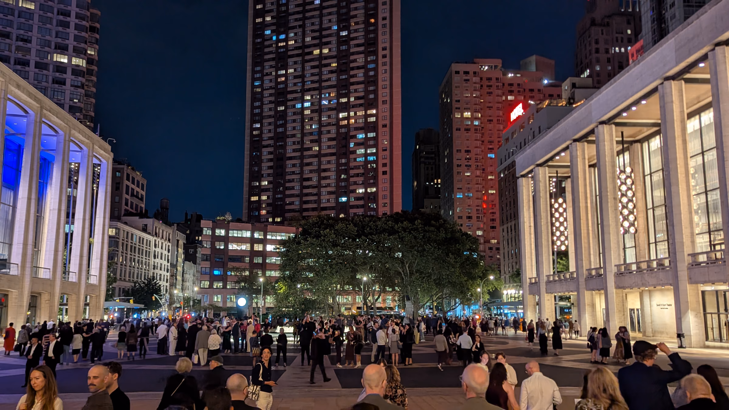 Lincoln Center’s illuminated plaza and performing arts buildings in Lincoln Square.