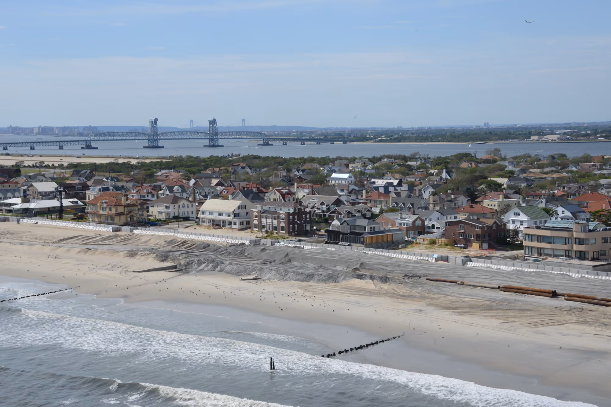 Aerial view of beachfront homes and the shoreline in Neponsit